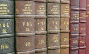 A row of 1910s journals on a shelf
