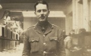 A man in First World War army uniform in a bank office